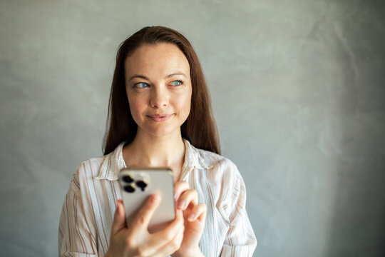 Young woman using smartphone indoors with copy space