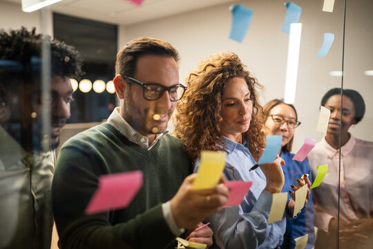 Diverse business team brainstorming ideas using sticky notes