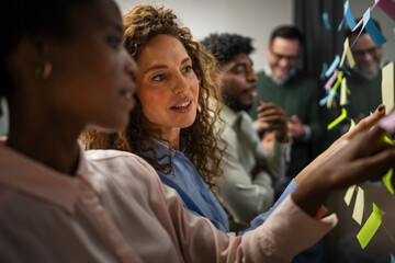 Diverse business team brainstorming ideas with sticky notes