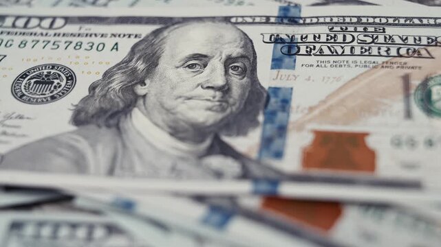 Close-up shots of US dollar banknotes showcasing intricate details and textures, highlighting the design elements and security features of the currency in a visually rich arrangement