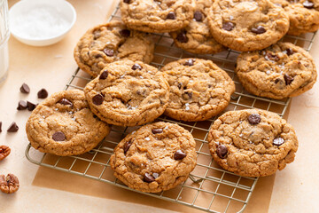 Chocolate chip cookies freshly baked on a cooling rack