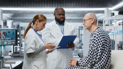 Medical researchers conducting patient evaluation in a laboratory drug study, collecting data on...