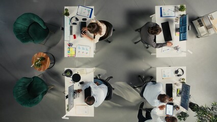Top down view of business people consulting on budgeting and resource allocation during corporate event. Multinational company work team analyzes data for partnership and strategic planning. © DC Studio