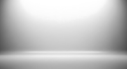 Minimalist studio background with bright white spotlight and subtle grey gradient, ideal for product display and design. © fackul