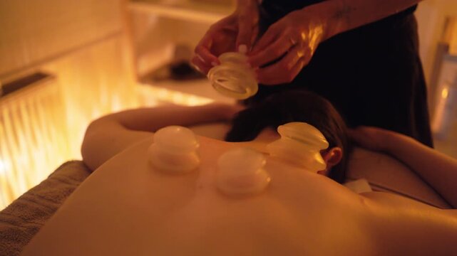 Therapist arranges jars for tension relief, Overhead perspective displaying jars in calming spa environment