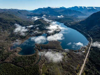 Aerial shot of Lake Machonico with scattered clouds in Patagonia Argentina