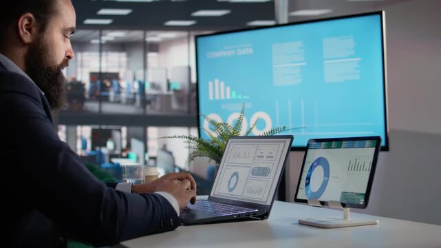 KPIs on tablet and laptop, CEO makes analysis, company data on screen, decision making and administration. Businessman reviews productivity with metrics, engaged in planning, insights.