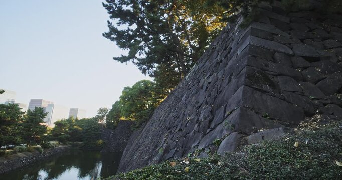 Epic stone hall of ancient Japanese castle near moat - morning