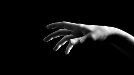 Fototapeta premium Reaching Hand: A grayscale image showcases a hand, fingers gently extended, reaching out from the shadows, bathed in soft, inviting light.