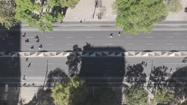 Aerial top down view over Paseo de la Reforma during the weekly "Cicloton" with runners and people on bicycle on both sides of the street. 