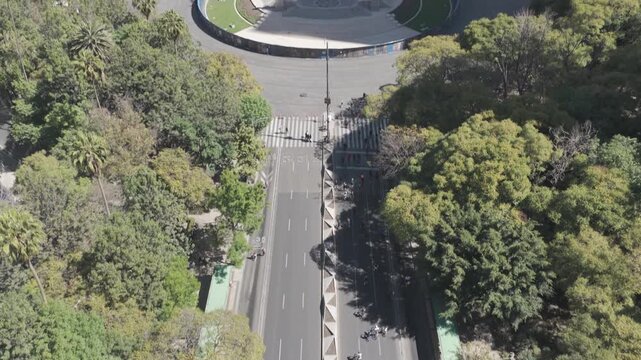 Aerial drone tilt up revealing &Aacute;ngel de la Independencia and Paseo de la Reforma skyline during Ciclot&oacute;n Dominical in M&eacute;xico City