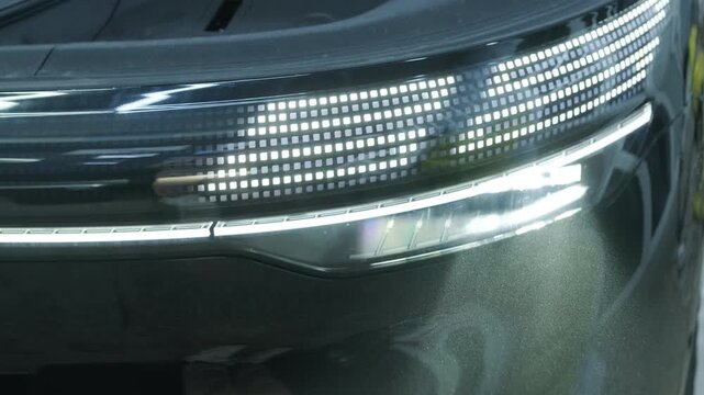 Close-up of modern car matrix LED headlights. Detail of futuristic automotive front lighting with pixel design.