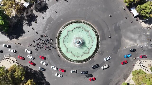 Aerial top down view over La Diana in Paseo de la Reforma during the weekly "Cicloton" with runners and people on bicycle.