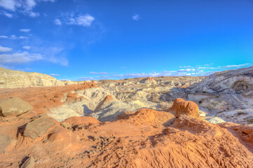 Fototapeta premium A desert landscape with a blue sky and a few clouds