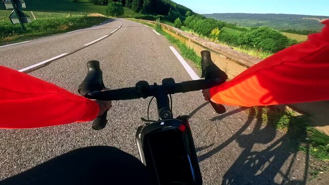 POV road cycling descent on a winding countryside road in French Alps