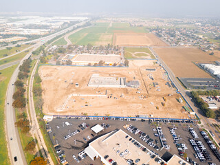 Aerial view of a large-scale construction site with heavy machinery and industrial building progress.ult