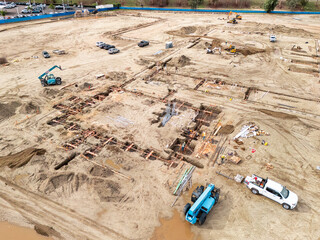 Aerial view of a large-scale construction site with heavy machinery and industrial building progress.ult