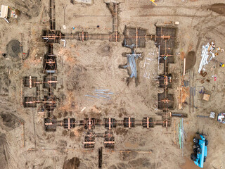 Aerial view of a large-scale construction site with heavy machinery and industrial building progress.ult