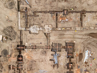 Aerial view of a large-scale construction site with heavy machinery and industrial building progress.ult