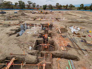 Aerial view of a large-scale construction site with heavy machinery and industrial building progress.ult