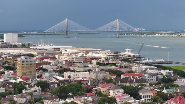 Panoramic aerial view of Arthur Ravenel Jr. Bridge in beautiful lowcountry landscapes of Charleston, South Carolina with views of downtown buildings and waterfront port seascape - 4K Drone