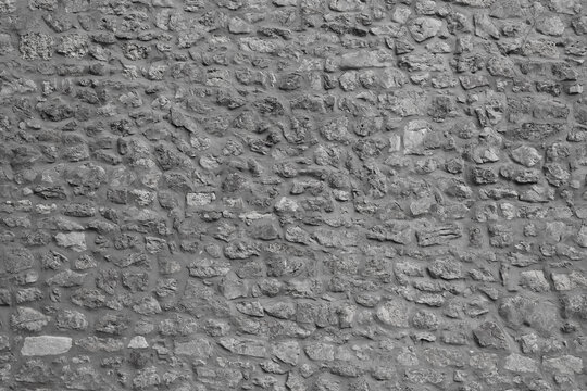 Background of stone floor texture. Seamless gray cobblestone wall or road background texture. Tileable natural rock and stone shaped path or walkway repeat surface pattern construction backdrop