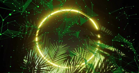 Naklejka premium Highlighting glowing neon ring emitting yellow light in studio set, with palm fronds and green mesh