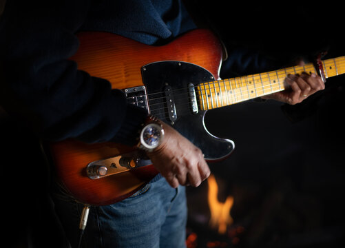 Fingers strumming on guitar 