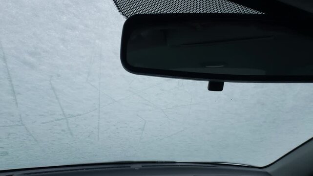 Winter frost significantly reduces driver visibility by covering windshield and obscuring view