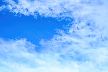 Fototapeta premium Bright blue sky with wispy white clouds over Yogyakarta, beautiful clear day landscape background