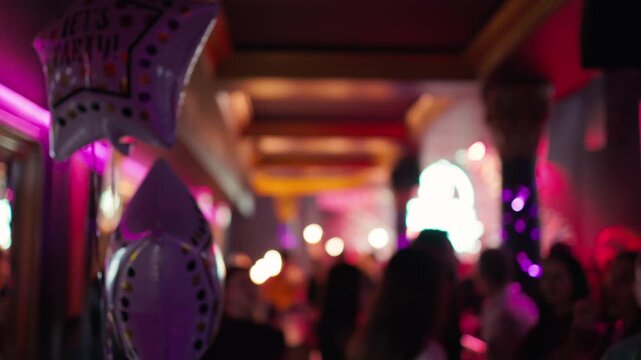 Vivid scene of lively club corridor illuminated by neon lights and decorated with reflective balloons