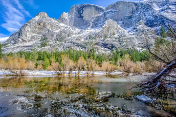 A mountain range with a lake in the foreground