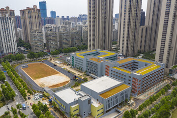 Modern School Complex with Yellow Roofs in Dense Urban City © HoangNgoc