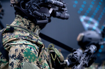 Modern soldier in digital camouflage holding tactical rifle during military operation