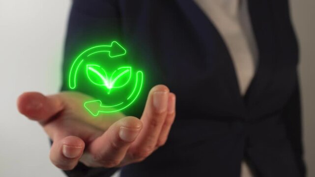 Woman's hand holding a virtual compost icon in neon light