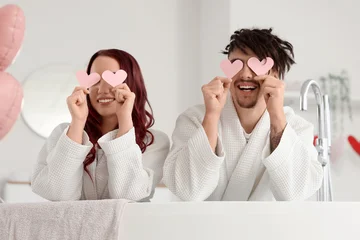 Fotobehang Onderzeeër Young lovely couple with paper hearts sitting in bathtub at home. Valentine's Day celebration  © Pixel-Shot