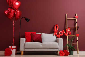 Interior of festive living room with grey sofa, gifts and heart-shaped balloons. Valentine's Day...
