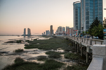 Dandong Cityscape at Sunset, Yalu River Waterfront, Liaoning Province China © PhamThi