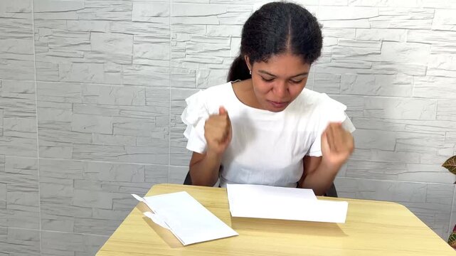 Young woman showing genuine excitement and happiness after reading a university acceptance letter