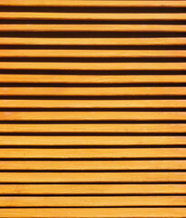 Fototapeta premium Horizontal wooden slat pattern featuring warm orange tones and clean geometric lines, providing a versatile texture for architectural and background designs