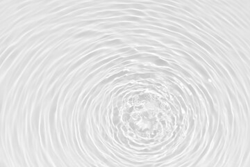 Fototapeta premium White water with ripples on the surface. Defocus blurred transparent white colored clear calm water surface texture with splashes and bubbles. Water waves with shining pattern texture background.