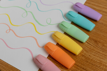 Pastel Highlighters Creating Colorful Wavy Lines on White Paper