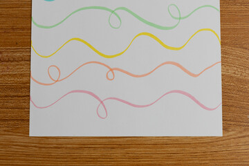 Colorful Pastel Wavy Lines on White Paper Flat Lay
