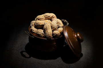 Roasted Peanut in Shell with Salt in a vintage metallic pot