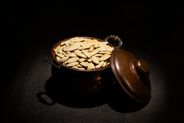 Roasted White Thin Pumpkin Seeds without Salt in a vintage metallic pot