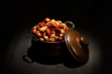 Roasted Small Red Peanuts without Salt in a vintage metallic pot