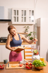 Fit woman enjoys healthy fruit breakfast after yoga training. fitness, nutrition, healthy lifestyle.