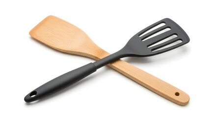 Naklejka premium Essential kitchen utensils, featuring a wooden spatula and a black non-stick flipper crossed over each other on a white background