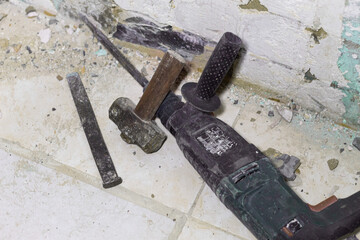 Power tools and hand tools used to demolish ceramic floors in a remodeling project. Demolition...