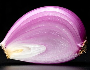 Close-up of a halved red onion revealing concentric rings, dark backdrop